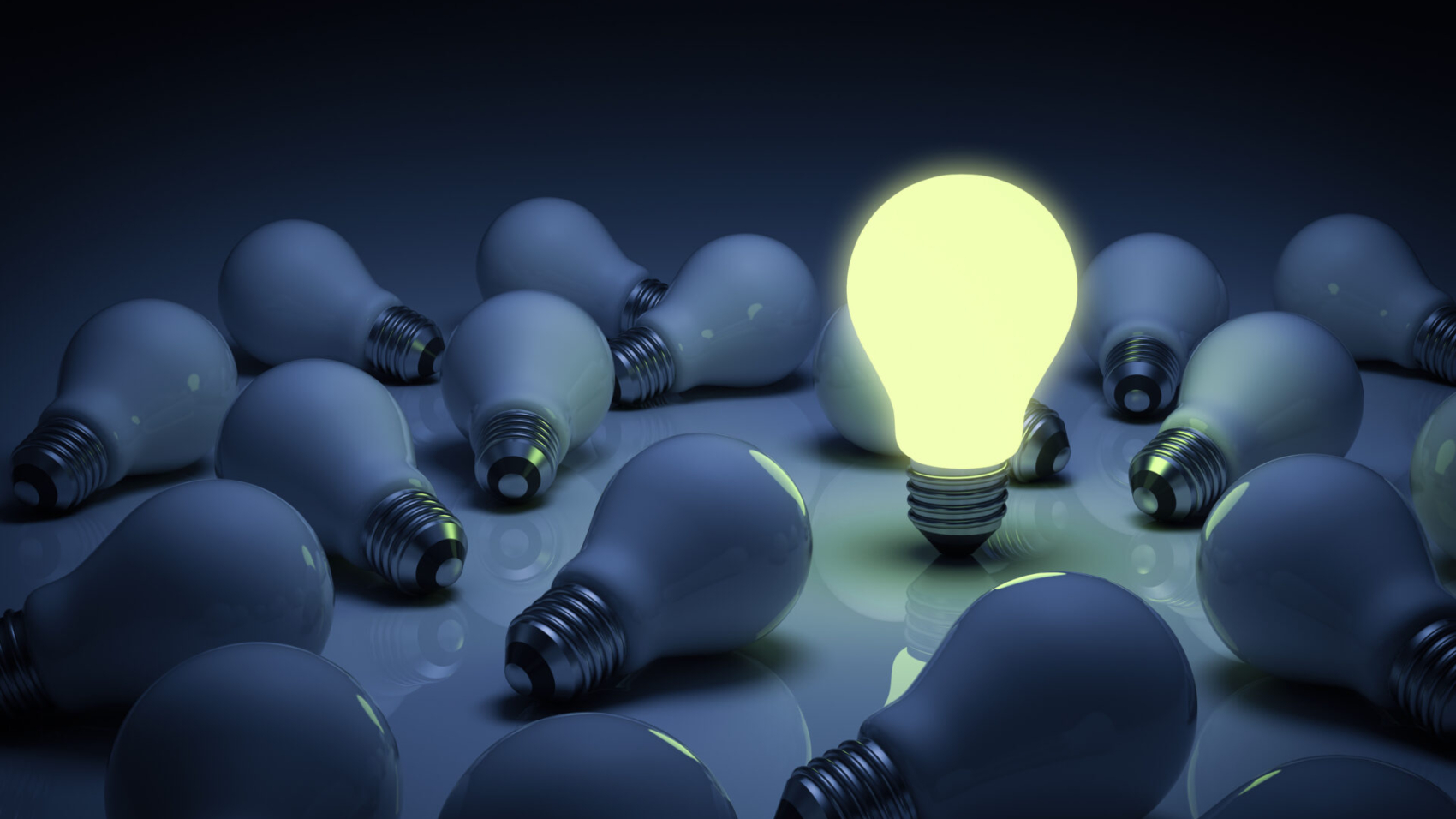 One,Glowing,Light,Bulb,Standing,Out,From,The,Unlit,Incandescent