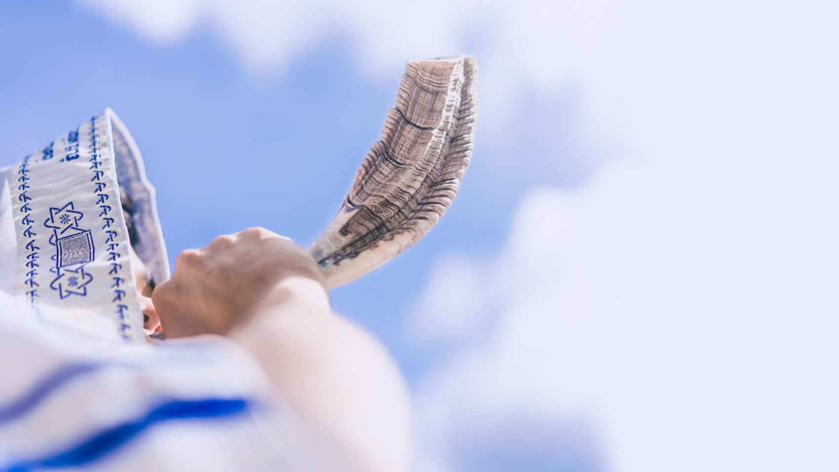 Happy Yom Kippur.Happy new year.Jewish man in Tallit blowing the Shofar (horn) of Rosh Hashanah (New Year Jew).Religious and Holidays in israel people of GOD.Peace Pray Freedom in Israel.Banner.