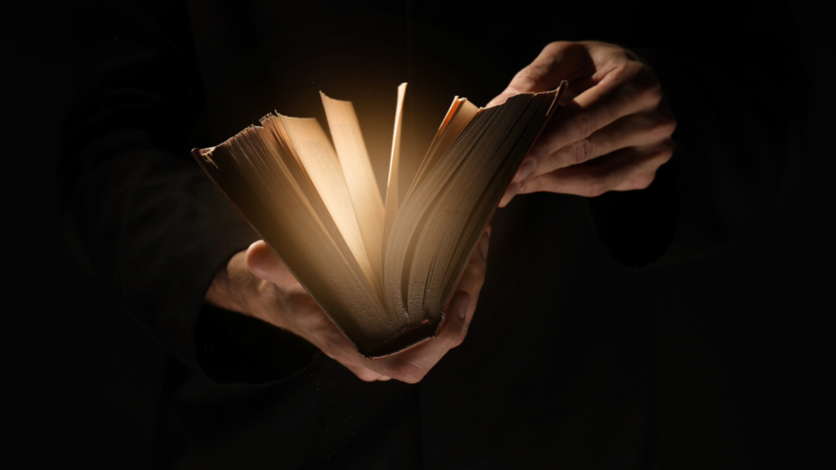 Priest,With,Old,Bible,On,Black,Background,,Closeup